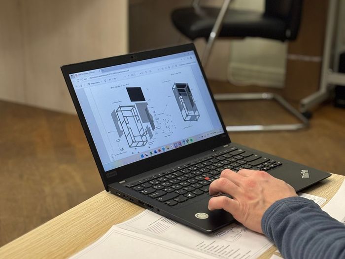 Technical drawings reviewed at a workshop desk